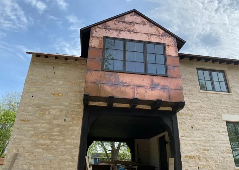 Copper metal panel facade on a stone building for Roof Repair in Fort Leonard Wood